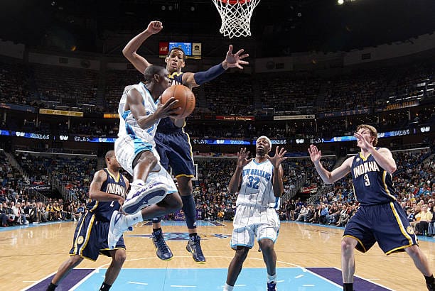 Darren Collison passes around Danny Granger